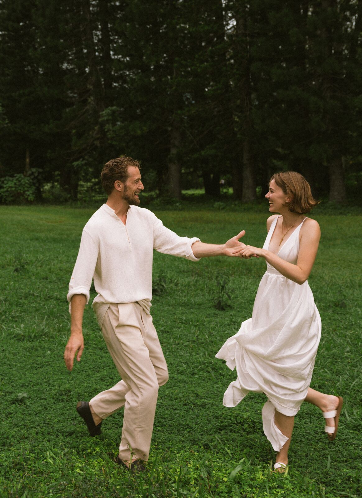 Carley & Tommy — dancing hand in hand on the lawn