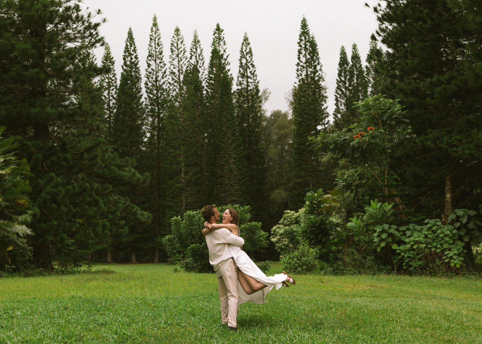 Carley & Tommy — dancing beneath tall pines, wide view
