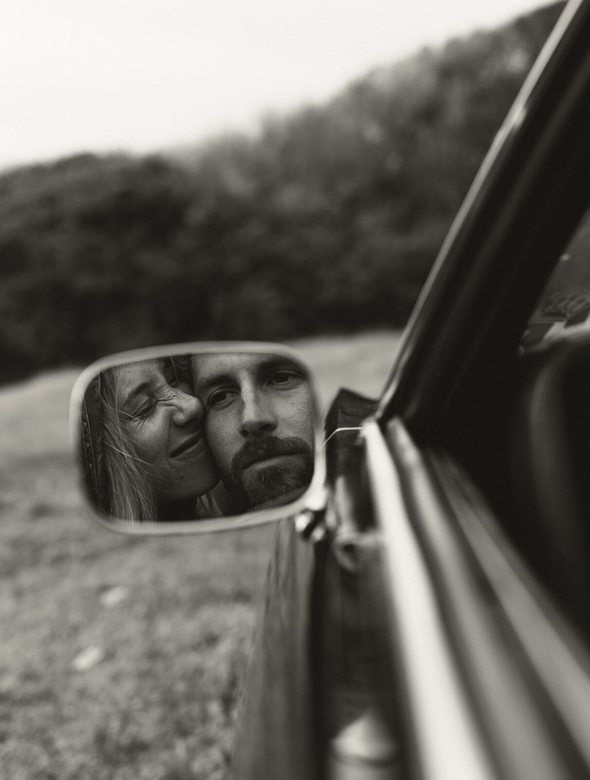 Claire & Jordan — the couple reflected in a classic car mirror
