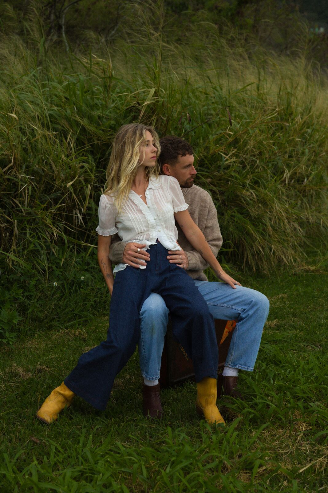 Claire & Jordan — sitting together on the car in a grassy field