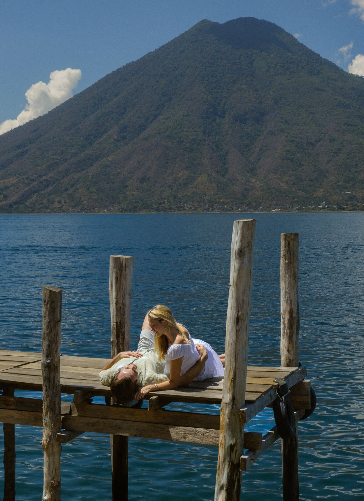 Kristina & Ty — the couple on a wooden dock over the volcanic lake