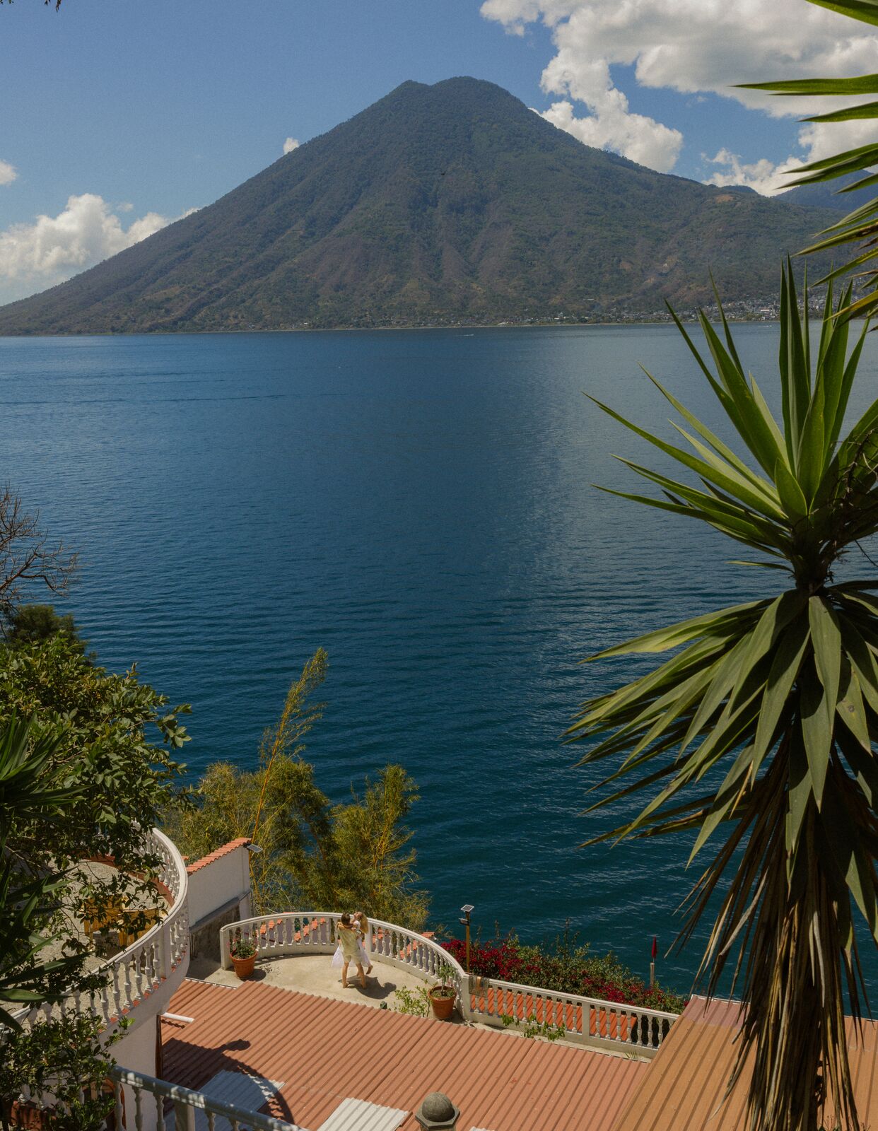 Kristina & Ty — seated on the dock facing the volcano