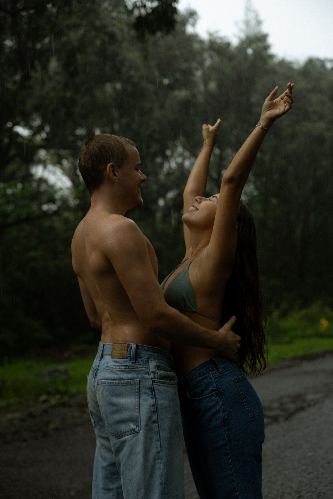 Noa & Mason — arms raised in the rain