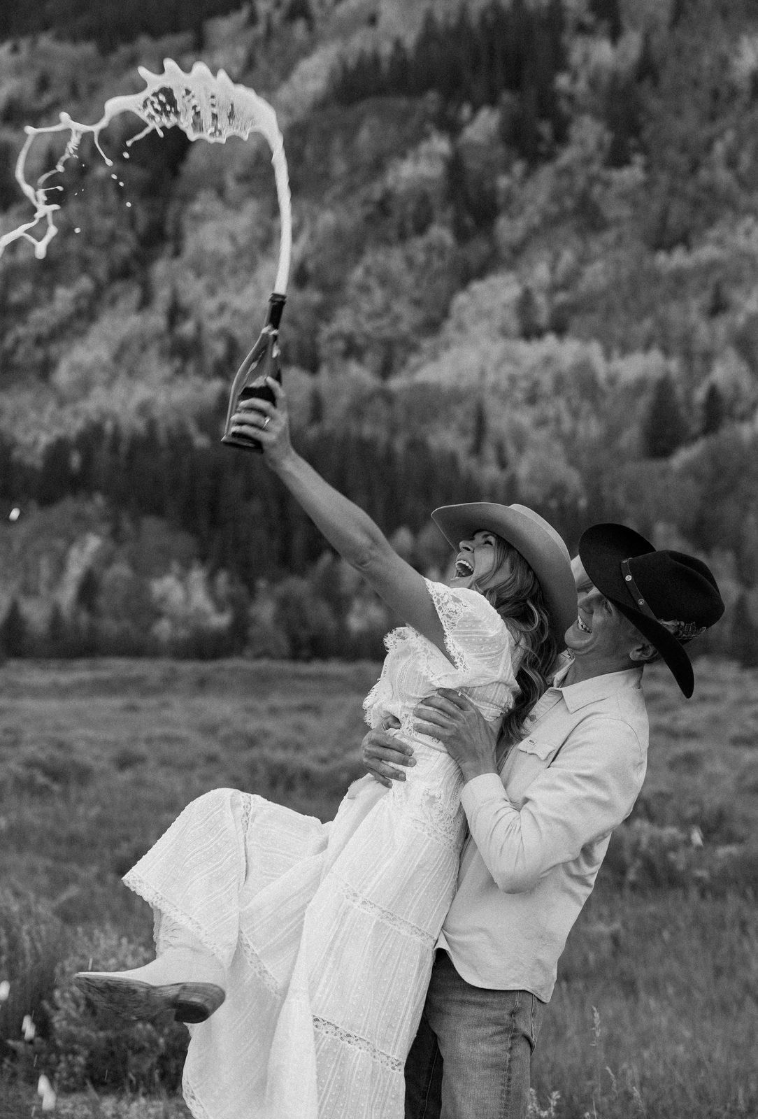 Couple celebrating with champagne, black and white