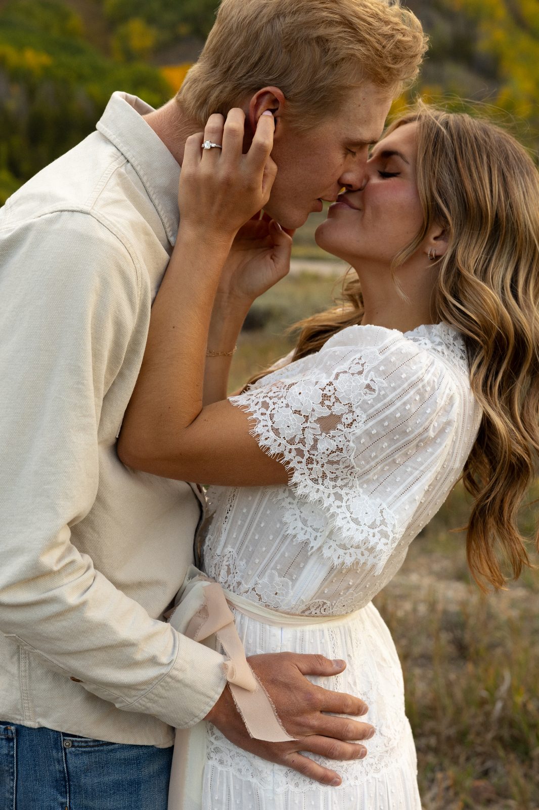 Couple kissing in a golden Colorado field